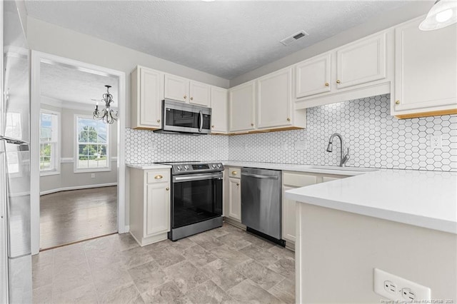 4404 Bunkers Bay Ln, Parkton, NC 28371 - kitchen with appliances with stainless steel finishes, a sink, light countertops, decorative backsplash, and a textured ceiling