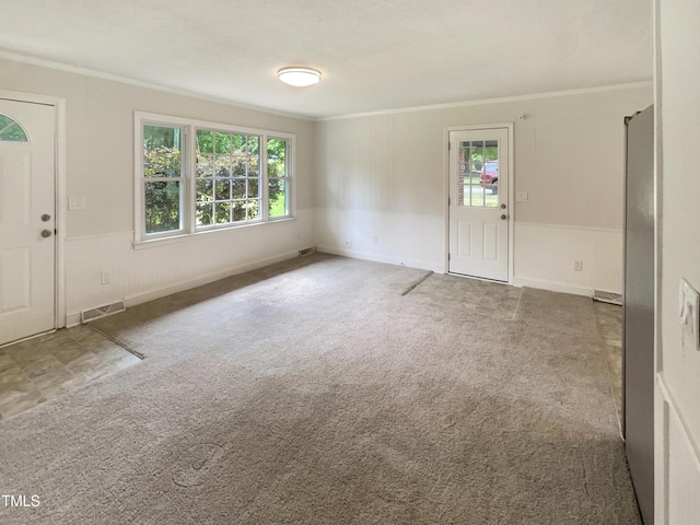 1413 Chamblee Rd, Zebulon, NC 27597 - foyer entrance with crown molding, plenty of natural light, wainscoting, and carpet floors