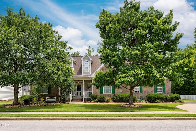 229 Hocutt Farm Dr, Clayton, NC 27527 - obstructed view of property featuring brick siding, a porch, and a front yard