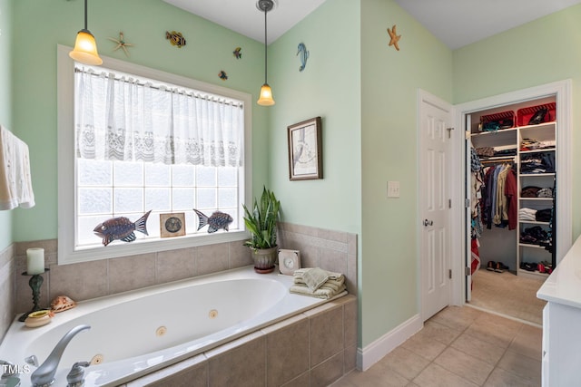 229 Hocutt Farm Dr, Clayton, NC 27527 - bathroom featuring a jetted tub, tile patterned flooring, baseboards, and a walk in closet