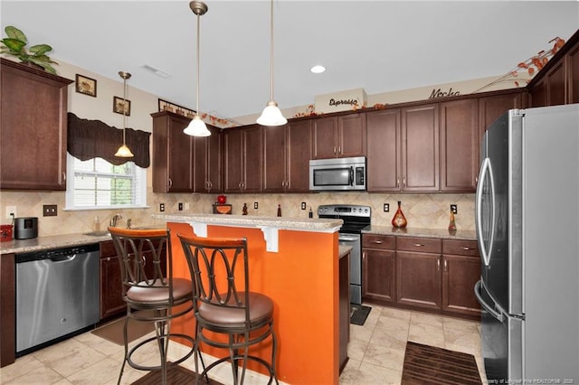 89 Revolutionary Rd, Cameron, NC 28326 - kitchen with stainless steel appliances, backsplash, a center island, a breakfast bar area, and recessed lighting