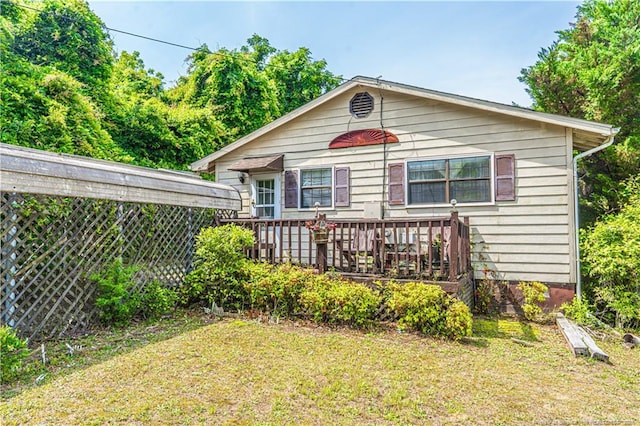 8212 Main St, West End, NC 27376 - rear view of property with a lawn and a wooden deck