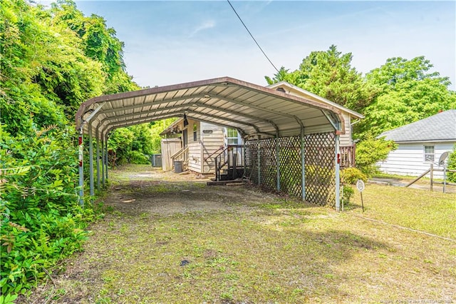 8212 Main St, West End, NC 27376 - view of parking featuring a carport and driveway