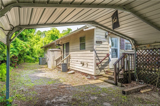 8212 Main St, West End, NC 27376 - view of side of home featuring a carport and central AC unit