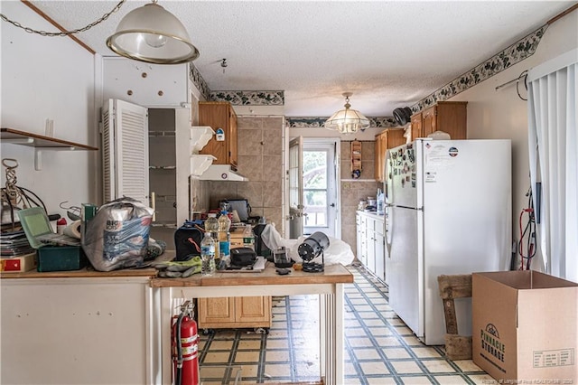 8212 Main St, West End, NC 27376 - kitchen featuring freestanding refrigerator, light floors, and a textured ceiling