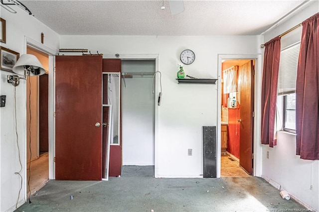8212 Main St, West End, NC 27376 - unfurnished bedroom featuring a closet, ceiling fan, and a textured ceiling