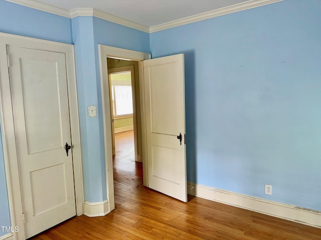 1609 Cypress Dr, Henderson, NC 27536 - spare room with baseboards, wood finished floors, and ornamental molding