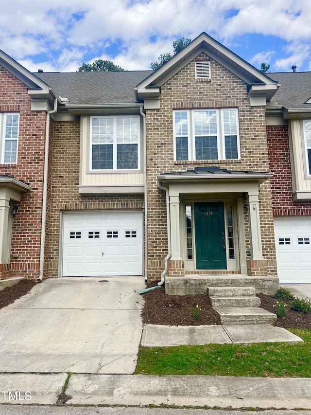 2118 Kedvale Ave, Raleigh, NC 27617 - view of front of house with concrete driveway, an attached garage, brick siding, and roof with shingles