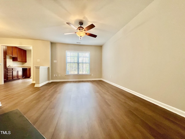 2118 Kedvale Ave, Raleigh, NC 27617 - unfurnished living room with ceiling fan, dark wood finished floors, and baseboards