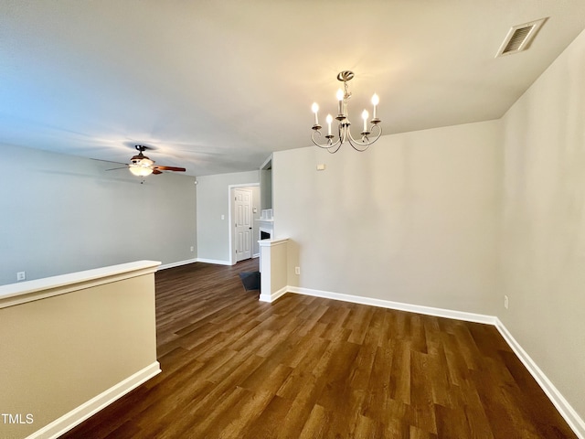 2118 Kedvale Ave, Raleigh, NC 27617 - spare room featuring baseboards, dark wood-style floors, a chandelier, and ceiling fan