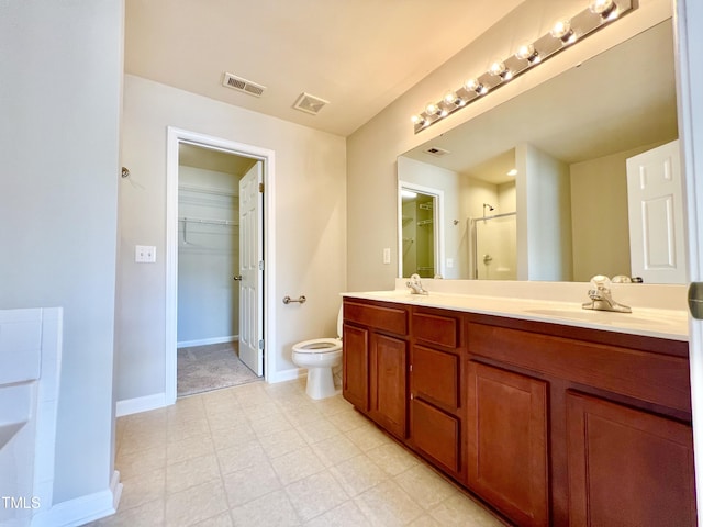 2118 Kedvale Ave, Raleigh, NC 27617 - bathroom with double vanity, a walk in closet, a shower with shower door, toilet, and baseboards