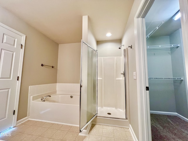 2118 Kedvale Ave, Raleigh, NC 27617 - full bath featuring a stall shower, a garden tub, a spacious closet, baseboards, and recessed lighting