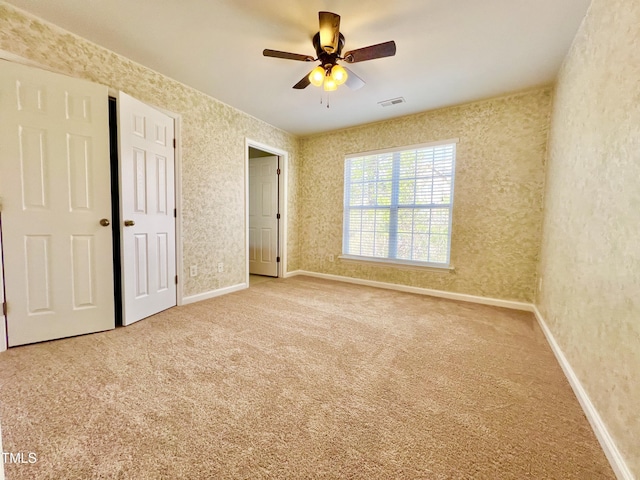 2118 Kedvale Ave, Raleigh, NC 27617 - unfurnished bedroom featuring carpet floors, baseboards, and a ceiling fan