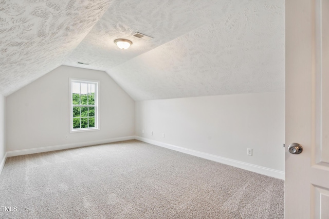 128 Newton Ct, Raeford, NC 28376 - additional living space with a textured ceiling, baseboards, carpet flooring, and lofted ceiling