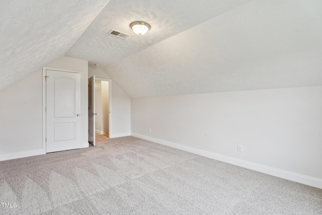 128 Newton Ct, Raeford, NC 28376 - bonus room featuring carpet flooring, lofted ceiling, baseboards, and a textured ceiling