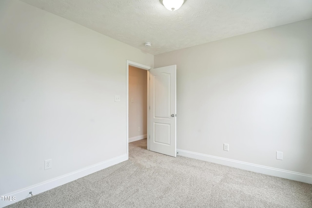 128 Newton Ct, Raeford, NC 28376 - spare room with light colored carpet, baseboards, and a textured ceiling