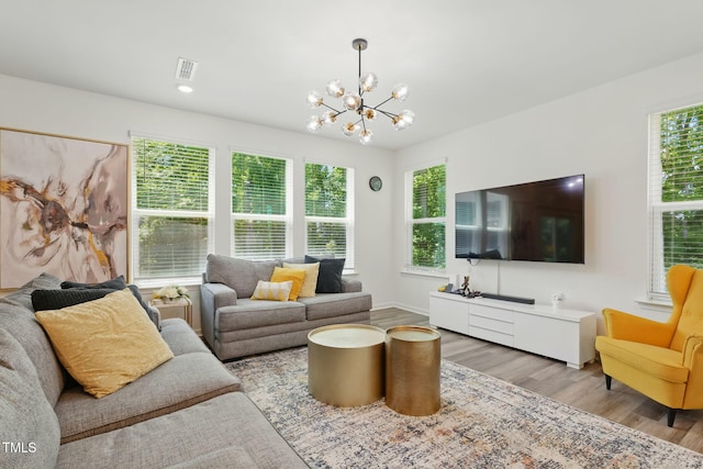 187 Harpers Landing Rd, Garner, NC 27529 - living area featuring a chandelier, wood finished floors, and baseboards