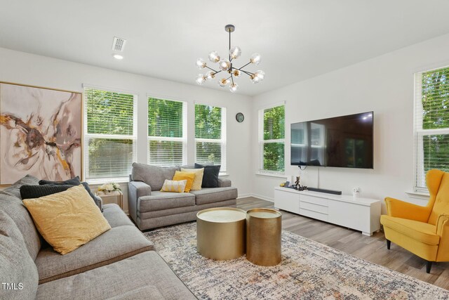 187 Harpers Landing Rd, Garner, NC 27529 - living area featuring a chandelier, wood finished floors, and baseboards