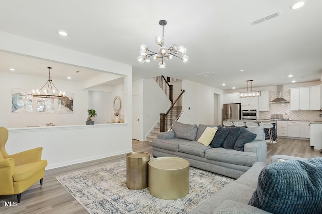 187 Harpers Landing Rd, Garner, NC 27529 - living area featuring a chandelier, light wood-style flooring, recessed lighting, and stairs