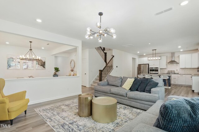 187 Harpers Landing Rd, Garner, NC 27529 - living area featuring a chandelier, light wood-style flooring, recessed lighting, and stairs