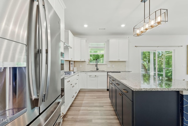 187 Harpers Landing Rd, Garner, NC 27529 - kitchen featuring appliances with stainless steel finishes, a sink, light wood-type flooring, a center island, and recessed lighting