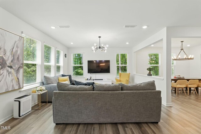 187 Harpers Landing Rd, Garner, NC 27529 - living area with a chandelier, wood finished floors, recessed lighting, and baseboards