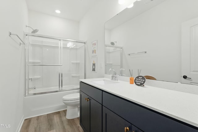 187 Harpers Landing Rd, Garner, NC 27529 - full bathroom with toilet, vanity, wood finished floors, and bath / shower combo with glass door