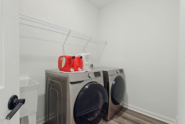 187 Harpers Landing Rd, Garner, NC 27529 - laundry area featuring independent washer and dryer, baseboards, and wood finished floors