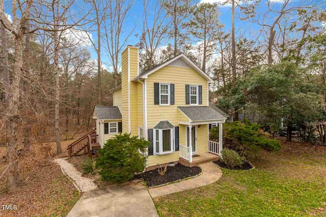 4009 Olde Coach Rd, Durham, NC 27707 - traditional-style house featuring a chimney, stairs, and a front lawn