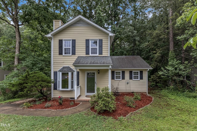 4009 Olde Coach Rd, Durham, NC 27707 - traditional-style home with a chimney, a front yard, and a shingled roof