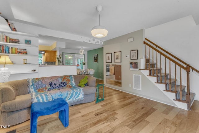 4009 Olde Coach Rd, Durham, NC 27707 - living area featuring stairs, light wood-style floors, and baseboards