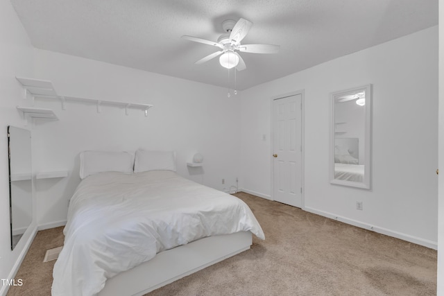 4009 Olde Coach Rd, Durham, NC 27707 - carpeted bedroom with baseboards, a ceiling fan, and a textured ceiling