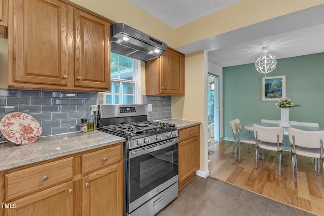 4009 Olde Coach Rd, Durham, NC 27707 - kitchen with gas range, range hood, decorative backsplash, tile patterned flooring, and a textured ceiling