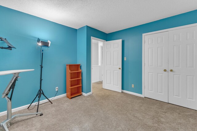4009 Olde Coach Rd, Durham, NC 27707 - unfurnished bedroom with carpet flooring, a textured ceiling, a closet, and baseboards