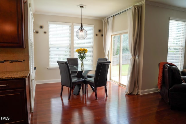 825 Fulworth Ave, Wake Forest, NC 27587 - dining room featuring healthy amount of natural light, ornamental molding, dark wood-style flooring, and a chandelier