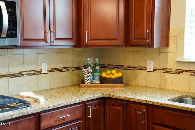 825 Fulworth Ave, Wake Forest, NC 27587 - kitchen with stainless steel microwave, backsplash, and dark brown cabinets