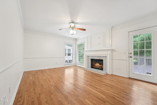 111 Catherwood Pl, Cary, NC 27518 - unfurnished living room with ornamental molding, light wood finished floors, a fireplace, a ceiling fan, and baseboards