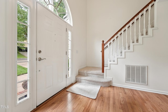 111 Catherwood Pl, Cary, NC 27518 - entryway featuring stairway, plenty of natural light, light wood-type flooring, and baseboards