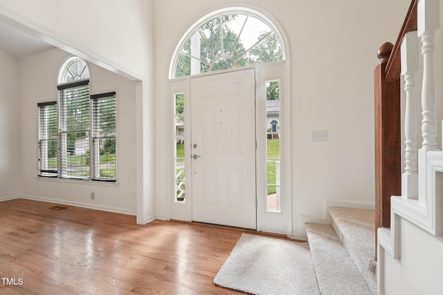 111 Catherwood Pl, Cary, NC 27518 - foyer featuring stairway, wood finished floors, baseboards, and a towering ceiling