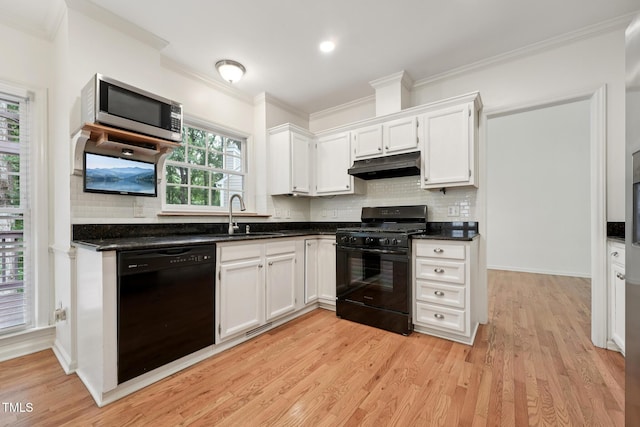 111 Catherwood Pl, Cary, NC 27518 - kitchen featuring black appliances, under cabinet range hood, a sink, ornamental molding, and dark countertops