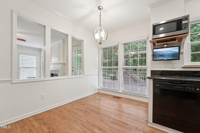 111 Catherwood Pl, Cary, NC 27518 - unfurnished dining area featuring light wood finished floors, plenty of natural light, ornamental molding, a chandelier, and baseboards
