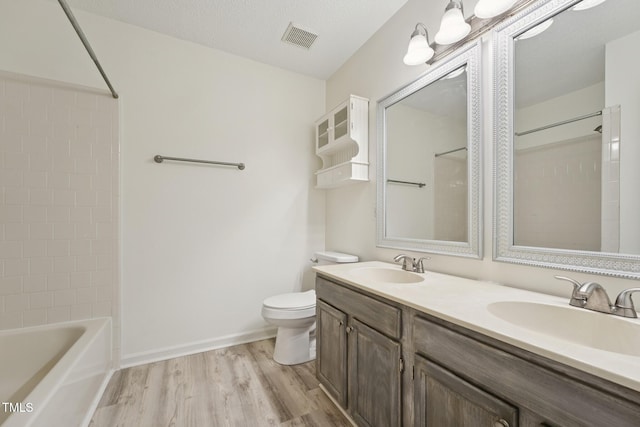 111 Catherwood Pl, Cary, NC 27518 - full bath featuring wood finished floors, double vanity, toilet, shower / tub combination, and baseboards