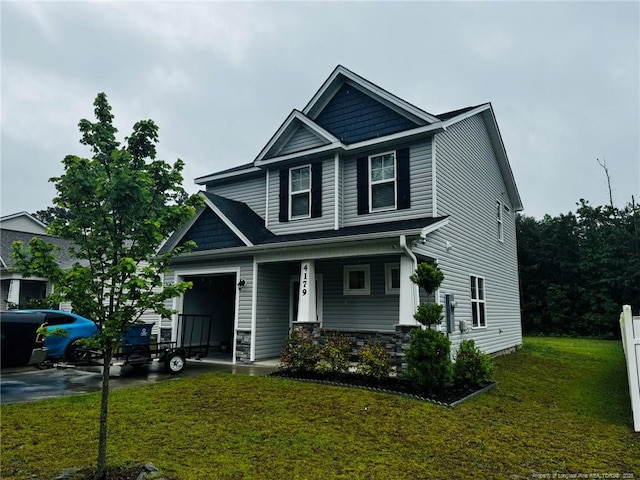 4179 Overhills Rd, Spring Lake, NC 28390 - craftsman-style home with a porch, a front lawn, stone siding, an attached garage, and driveway