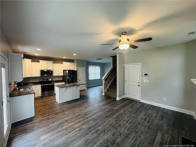 4179 Overhills Rd, Spring Lake, NC 28390 - kitchen featuring stainless steel appliances, dark countertops, a sink, a kitchen island, and ceiling fan