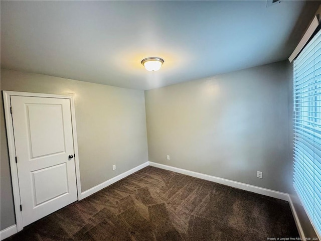 4179 Overhills Rd, Spring Lake, NC 28390 - empty room with dark colored carpet and baseboards