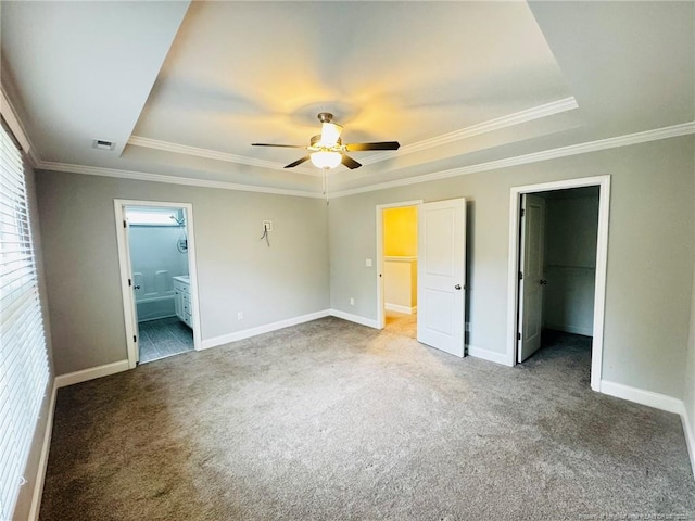 4179 Overhills Rd, Spring Lake, NC 28390 - unfurnished bedroom featuring a raised ceiling, carpet floors, a spacious closet, baseboards, and crown molding