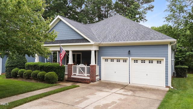 2313 Filigree Ct, Raleigh, NC 27614 - craftsman house featuring an attached garage, driveway, a shingled roof, and a porch