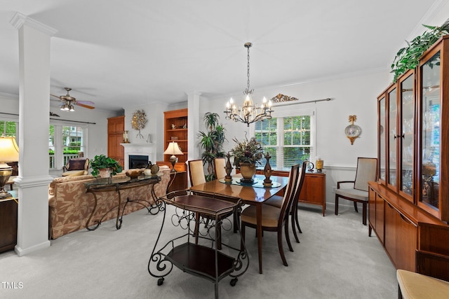 2313 Filigree Ct, Raleigh, NC 27614 - dining area featuring light colored carpet, ceiling fan, a glass covered fireplace, a chandelier, and ornamental molding