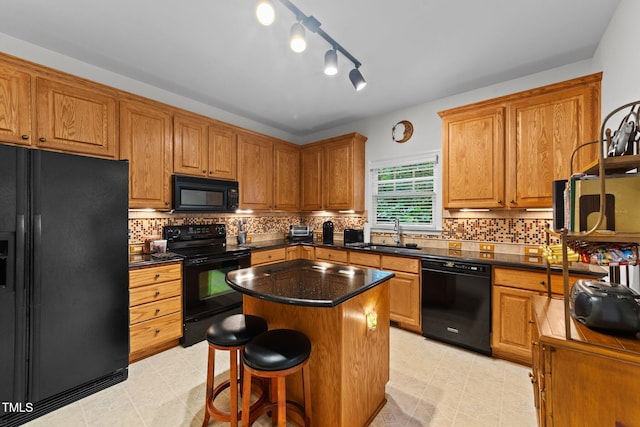 2313 Filigree Ct, Raleigh, NC 27614 - kitchen with black appliances, a sink, brown cabinetry, a kitchen island, and a breakfast bar area