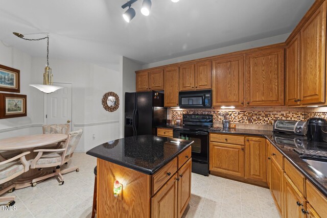 2313 Filigree Ct, Raleigh, NC 27614 - kitchen with black appliances, brown cabinets, backsplash, dark stone counters, and a center island